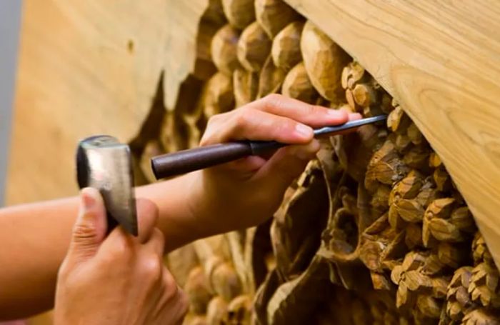 hand carving wood structure using chisel and hammer