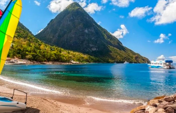 serene waters along the beach in St. Lucia with a stunning view of the mountains