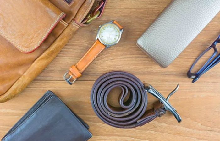 a leather backpack, belt, watch, wallet, and glasses case