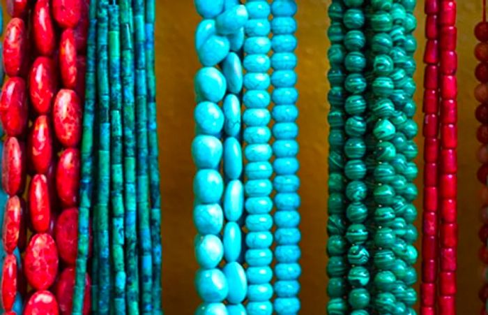 various coral and turquoise necklaces showcased