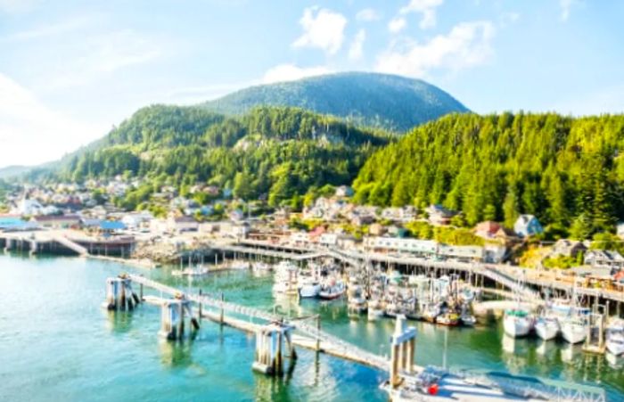 Aerial view of Ketchikan, Alaska, bathed in sunlight on a clear day.