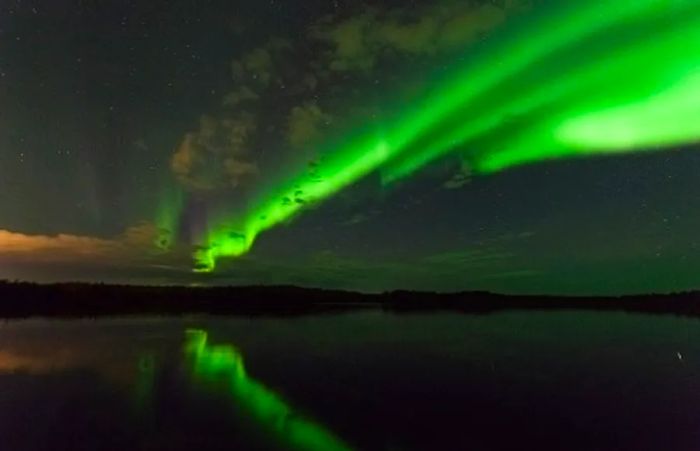 Aurora borealis shimmering over the water in Alaska