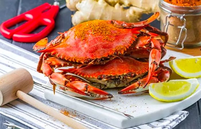 a pair of crabs from Grenada being seasoned with local spices and lime juice