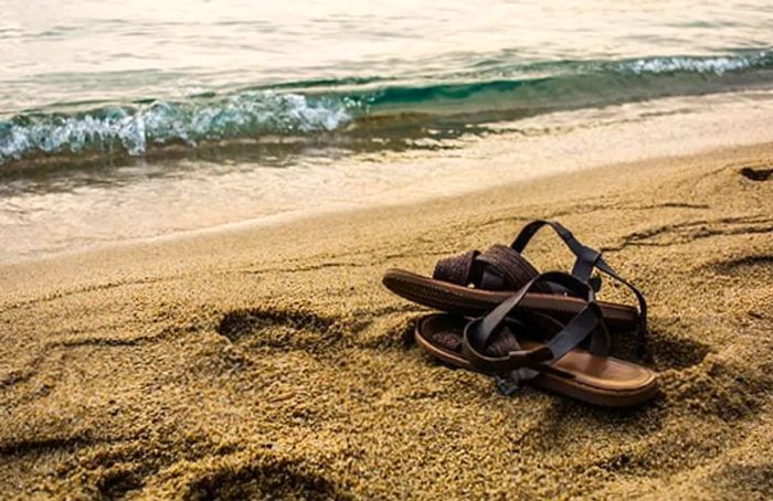 custom leather sandals on a Caribbean beach