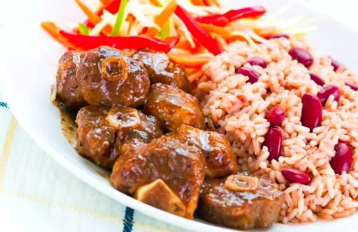 oxtail served alongside rice, beans, and salad from Ocho Rios