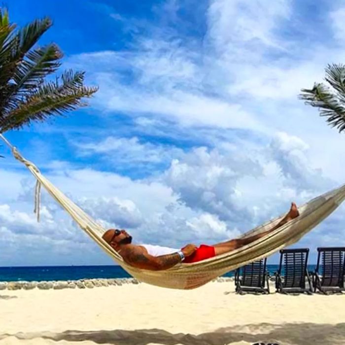 a person relaxing on a hammock in Cozumel