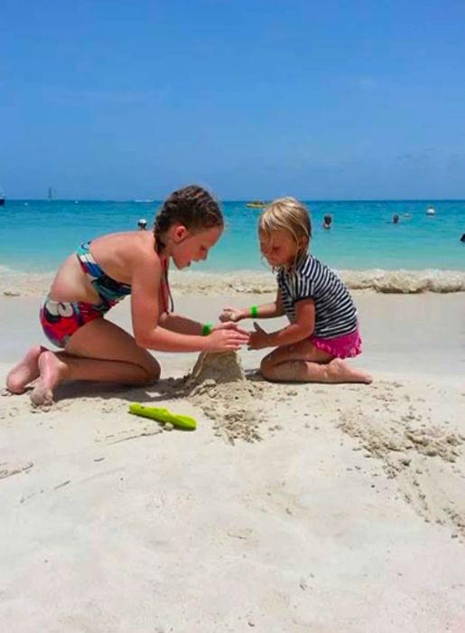 two girls creating a sandcastle