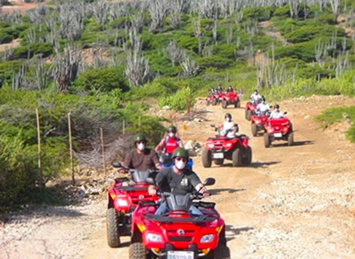 a group of adventurers exploring Bonaire’s east coast on ATVs