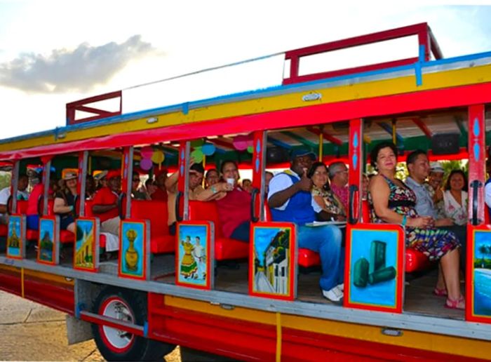 Tourist enjoying a ride on a colorful party bus in Cartagena