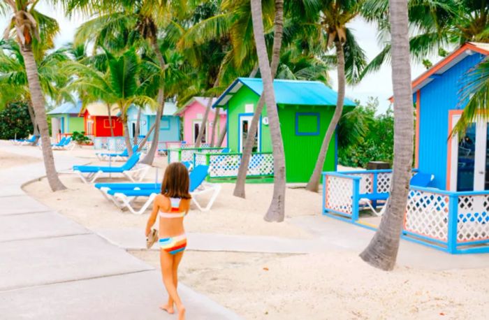 daughter strolling in her swimsuit near vibrant bungalows