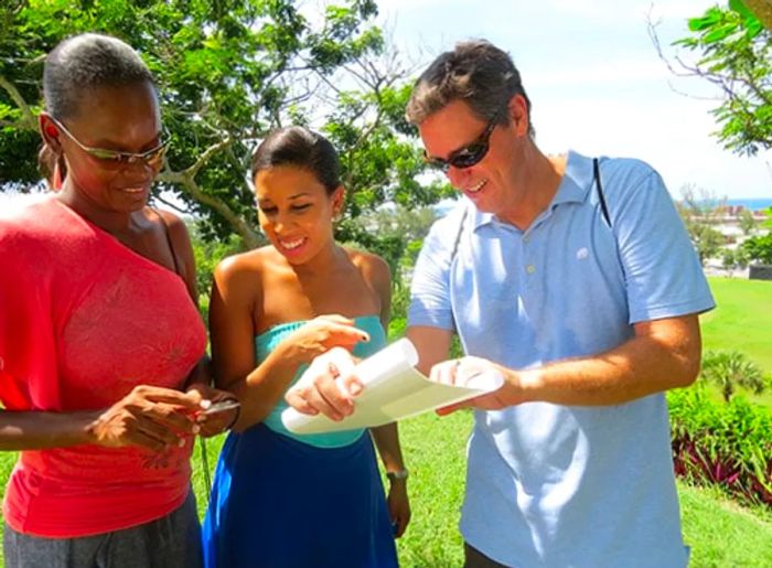 friends examining a map and using a compass during a scavenger hunt in a native quest competition