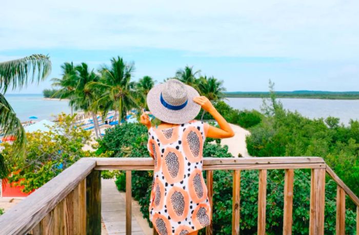 Drea gazing out towards the beach in her patterned dress