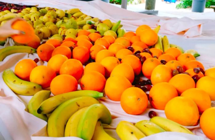 a colorful assortment of oranges, bananas, and grapes