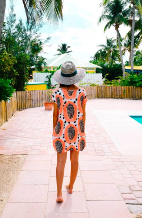 Drea strolling by the pool in a patterned dress