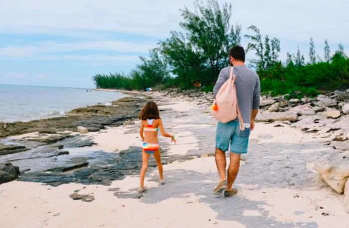 father and daughter strolling along the shoreline