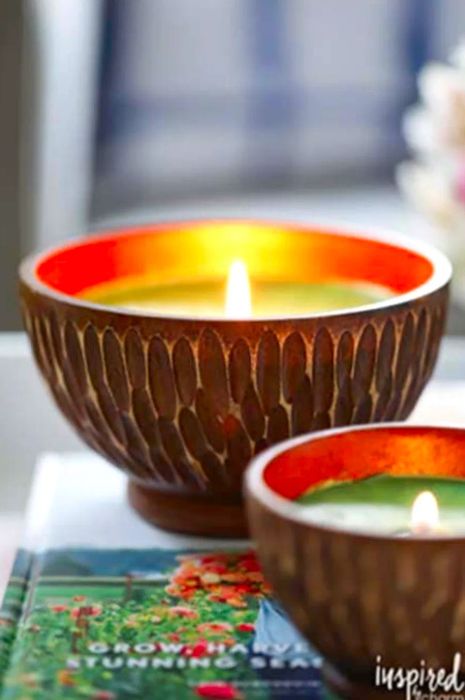 Two lit candles resting on a book