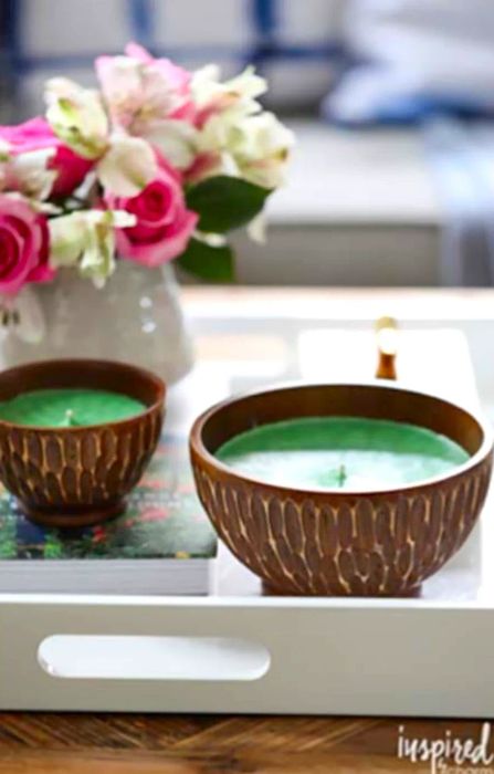 Two candles placed on a white tray adorned with flowers