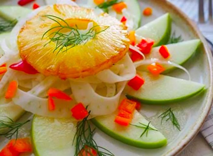 A close-up image of charred pineapple and fennel salad