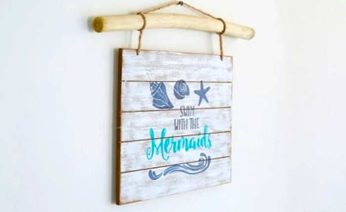 beadboard sign featuring the phrase 'swim with the mermaids'