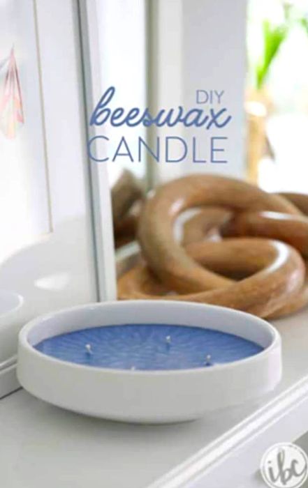 Promotional image of a DIY beeswax candle with a white holder