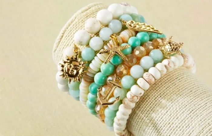 Seven mint and ivory bracelets adorned with sea-themed charms