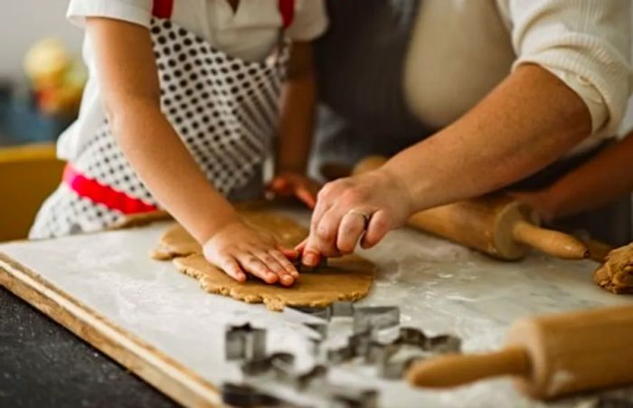 A family joyfully cutting gingerbread cookies together