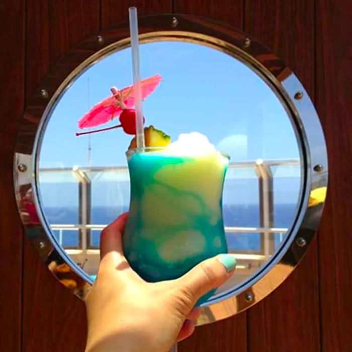 a cocktail in front of a porthole