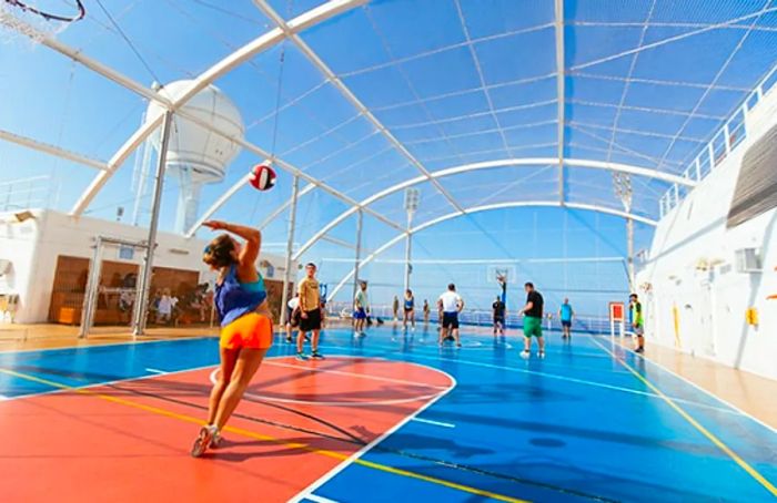 a woman serving the ball during a volleyball game at SportsSquare