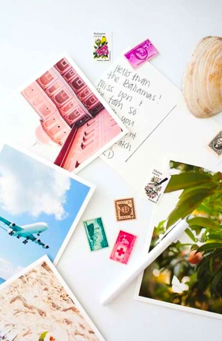 A collection of postcards and stamps scattered across a table