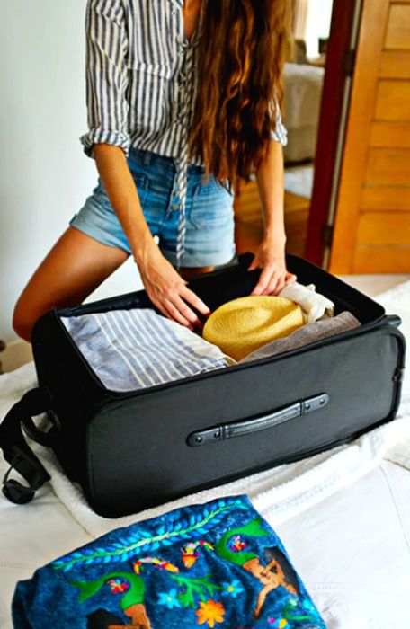 A packed suitcase resting on a bed.