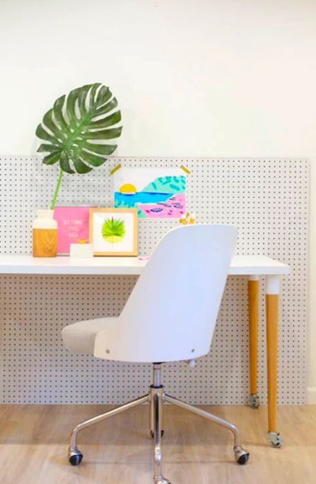 A white chair and desk adorned with lively decorations