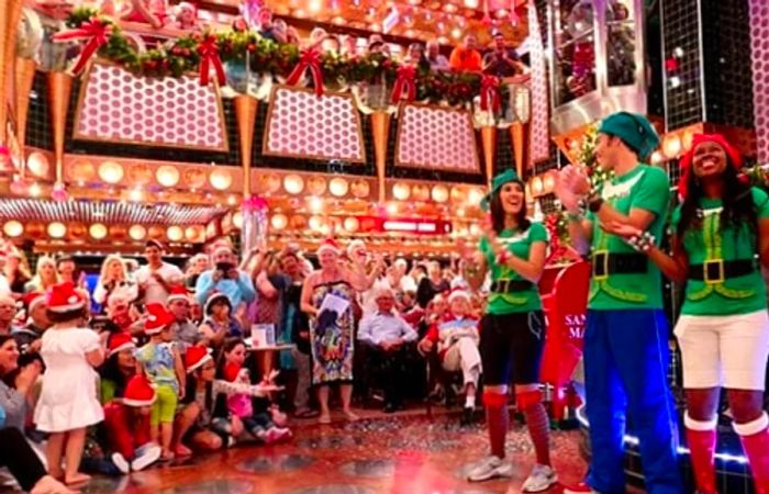 A gathering of friends and family celebrating together in the atrium during the holidays