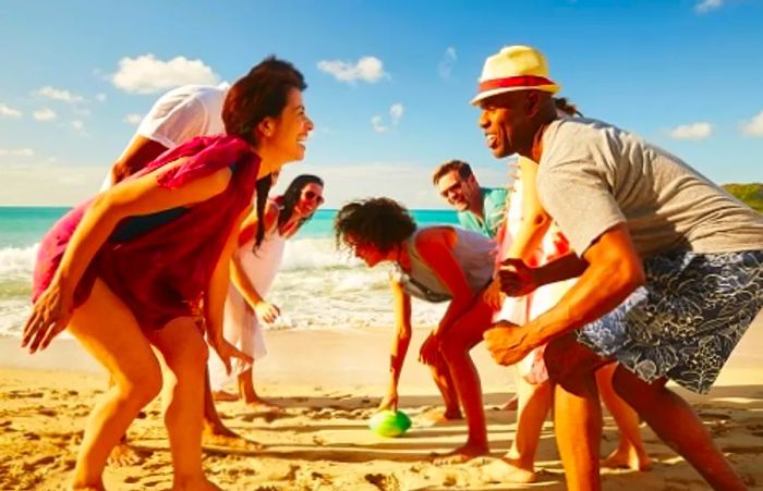 families gathering to play football on the beach