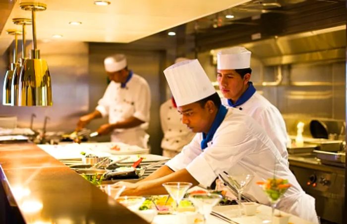 Chefs crafting exquisite meals aboard Dinogo’s Steakhouse.