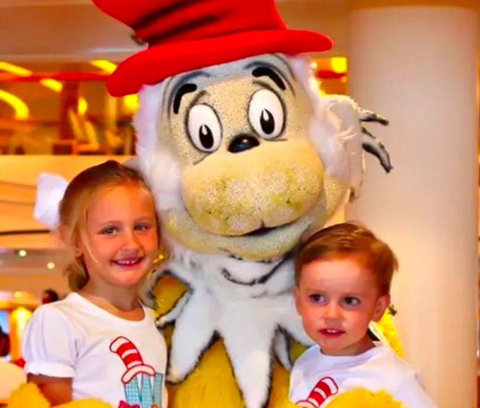 children interacting with a Dr. Seuss character at the Green Eggs and Ham Breakfast