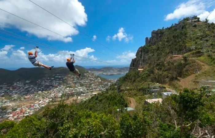 a pair of individuals zip-lining in St. Maarten