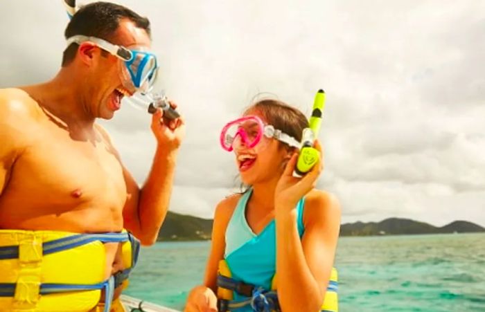 a father and daughter sharing a laugh before their snorkeling experience