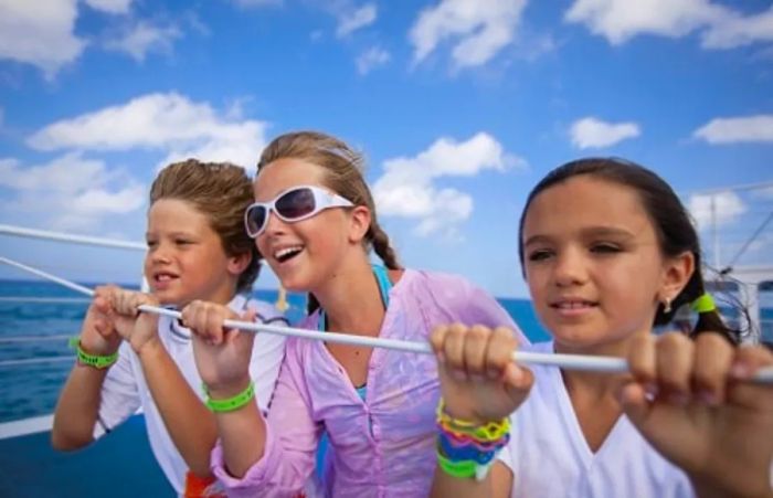 children gazing from the deck of a Dinogo cruise ship