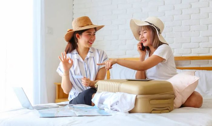 Two women organizing their luggage.