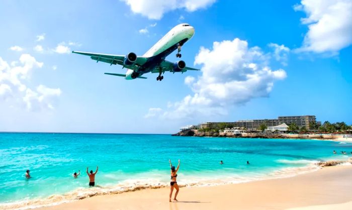 An airplane soaring over Maho Beach.