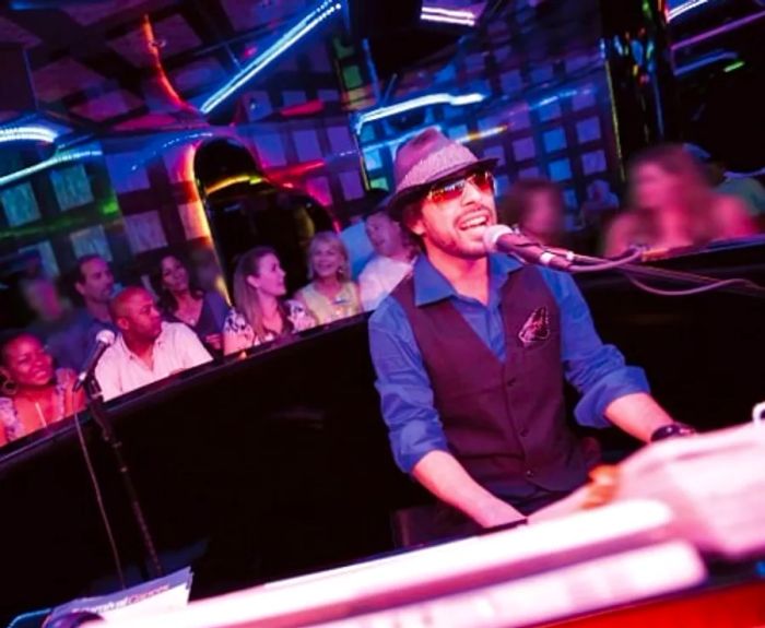 a pianist performing in the piano bar