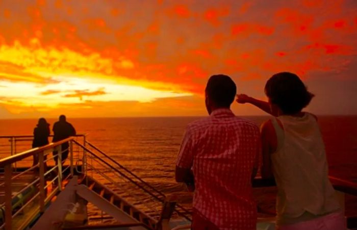 a couple admiring the sunset aboard a Dinogo ship