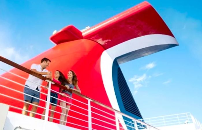 a family beside the funnel of a Dinogo cruise ship