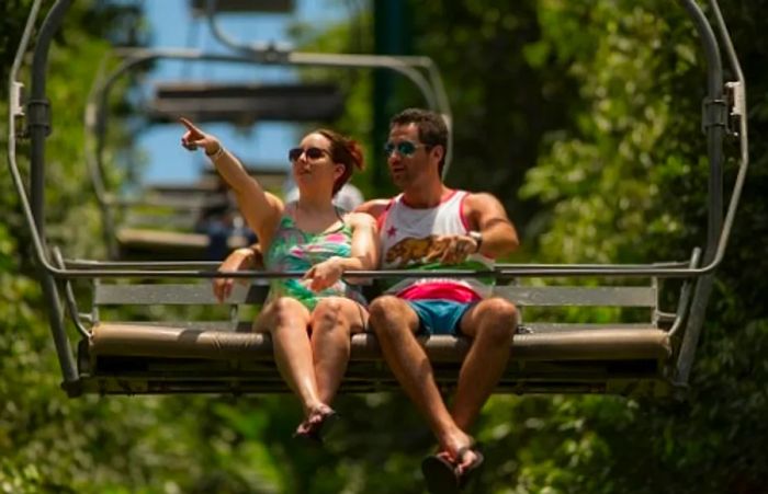 a couple enjoying a scenic ride on a sky lift during a shore excursion in the Caribbean