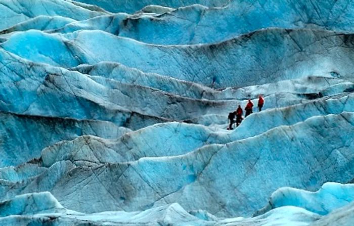 hikers making their way to an Alaskan glacier