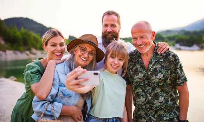 A joyful multi-generational family capturing a selfie on vacation.