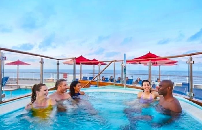 Friends enjoying time together at the onboard pool during their cruise vacation.