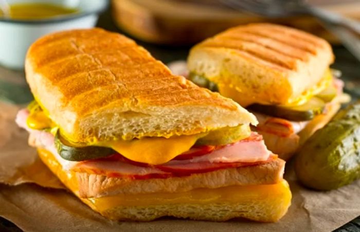 A freshly made Cuban sandwich served with a pickle at a Tampa restaurant.