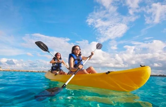 two young girls kayaking on the ocean