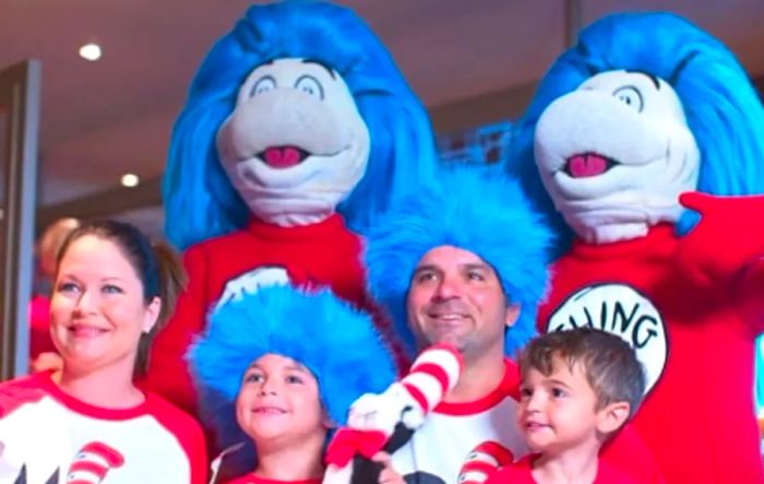 A family posing with Thing 1 and Thing 2 during the Green Eggs and Ham breakfast on Dinogo Magic.